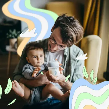 Ein Vater gibt seinem Baby eine Flasche Milch